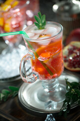 Cocktail in a glass with fruit on an old background.