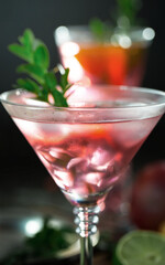 Fruit cocktail, in a glass with natural healthy fruits on a table with kitchen accessories.