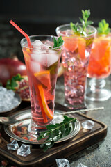 Fruit cocktail, in a glass with natural healthy fruits on a table with kitchen accessories.