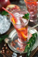 Fruit cocktail, in a glass with natural healthy fruits on a table with kitchen accessories.