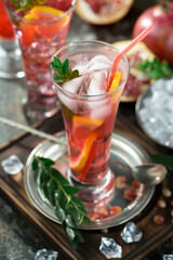 Fruit cocktail, in a glass with natural healthy fruits on a table with kitchen accessories.