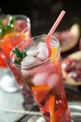 Cocktail in a glass with fruit on an old background.