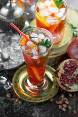 Fruit cocktail, in a glass with natural healthy fruits on a table with kitchen accessories.