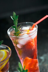 Cocktail in a glass with fruit on an old background.