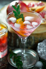 Fruit cocktail, in a glass with natural healthy fruits on a table with kitchen accessories.