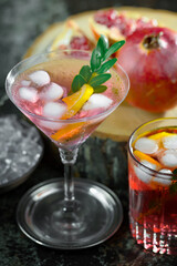 Cocktail in a glass with fruit on an old background.