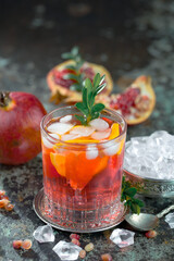 Cocktail in a glass with fruit on an old background.
