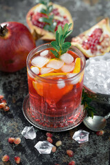 Fruit cocktail, in a glass with natural healthy fruits on a table with kitchen accessories.