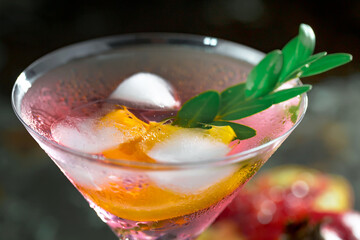 Cocktail in a glass with fruit on an old background.