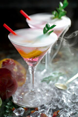 Cocktail in a glass with fruit on an old background.