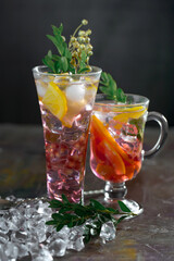 Fruit cocktail, in a glass with natural healthy fruits on a table with kitchen accessories.