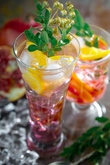 Fruit cocktail, in a glass with natural healthy fruits on a table with kitchen accessories.