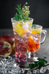Fruit cocktail, in a glass with natural healthy fruits on a table with kitchen accessories.