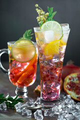 Fruit cocktail, in a glass with natural healthy fruits on a table with kitchen accessories.