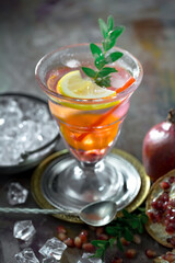 Fruit cocktail, in a glass with natural healthy fruits on a table with kitchen accessories.