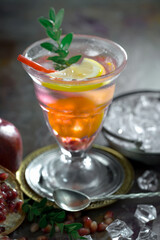 Cocktail in a glass with fruit on an old background.