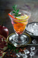 Fruit cocktail, in a glass with natural healthy fruits on a table with kitchen accessories.