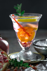 Cocktail in a glass with fruit on an old background.