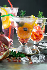 Cocktail in a glass with fruit on an old background.
