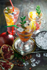 Cocktail in a glass with fruit on an old background.
