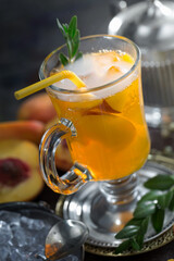 Fruit cocktail, in a glass with natural healthy fruits on a table with kitchen accessories.