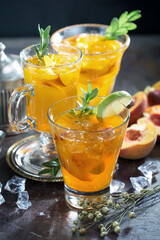 Cocktail in a glass with fruit on an old background.