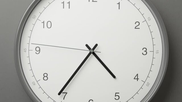 Clock Face on Dark Grey Office Wall in Timelapse