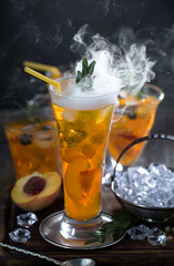 Fruit cocktail, in a glass with natural healthy fruits on a table with kitchen accessories.