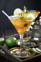 Cocktail in a glass with fruit on an old background.