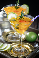 Fruit cocktail, in a glass with natural healthy fruits on a table with kitchen accessories.
