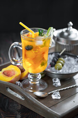 Fruit cocktail, in a glass with natural healthy fruits on a table with kitchen accessories.