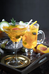 Fruit cocktail, in a glass with natural healthy fruits on a table with kitchen accessories.