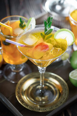 Fruit cocktail, in a glass with natural healthy fruits on a table with kitchen accessories.