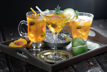 Cocktail in a glass with fruit on an old background.