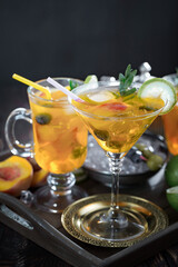 Fruit cocktail, in a glass with natural healthy fruits on a table with kitchen accessories.