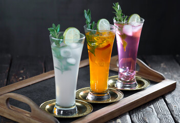 Cocktail in a glass with fruit on an old background.