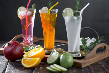 Fruit cocktail, in a glass with natural healthy fruits on a table with kitchen accessories.