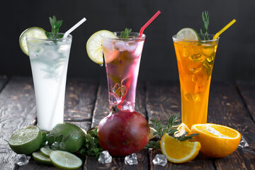 Fruit cocktail, in a glass with natural healthy fruits on a table with kitchen accessories.