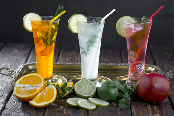 Fruit cocktail, in a glass with natural healthy fruits on a table with kitchen accessories.