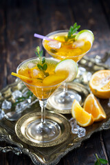 Cocktail in a glass with fruit on an old background.