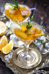 Fruit cocktail, in a glass with natural healthy fruits on a table with kitchen accessories.