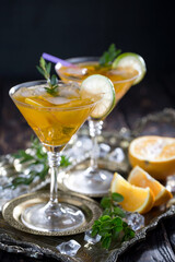 Cocktail in a glass with fruit on an old background.