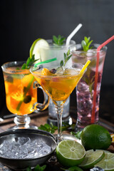 Cocktail in a glass with fruit on an old background.