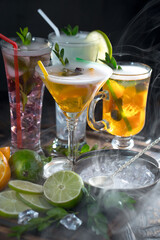 Fruit cocktail, in a glass with natural healthy fruits on a table with kitchen accessories.