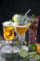 Fruit cocktail, in a glass with natural healthy fruits on a table with kitchen accessories.