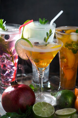 Fruit cocktail, in a glass with natural healthy fruits on a table with kitchen accessories.