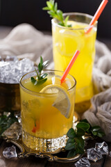 Fruit cocktail, in a glass with natural healthy fruits on a table with kitchen accessories.