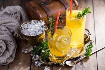 Fruit cocktail, in a glass with natural healthy fruits on a table with kitchen accessories.