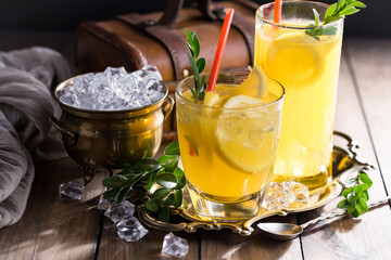 Cocktail in a glass with fruit on an old background.