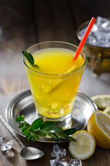 Cocktail in a glass with fruit on an old background.